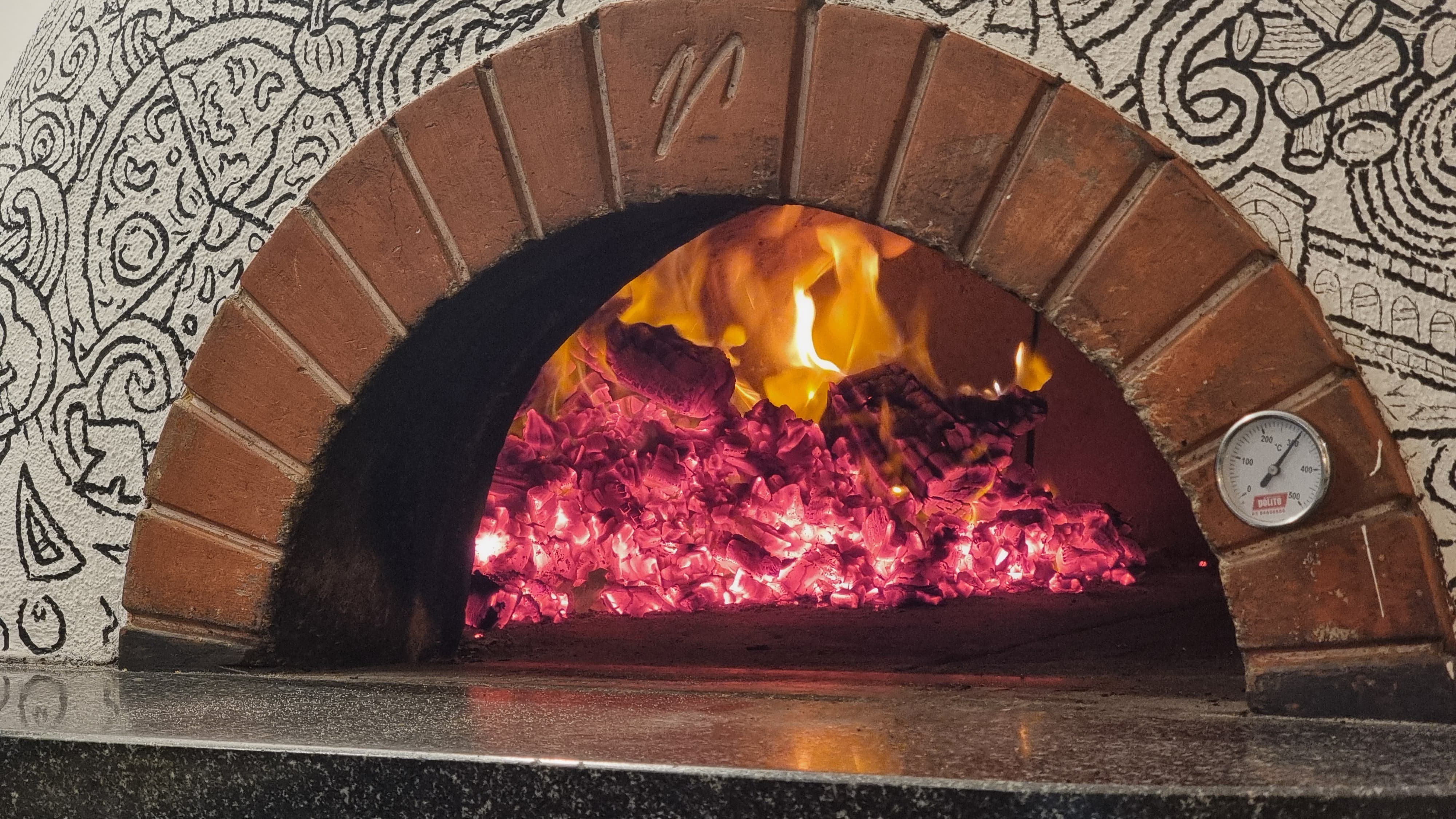 Wood-fired oven with flames inside