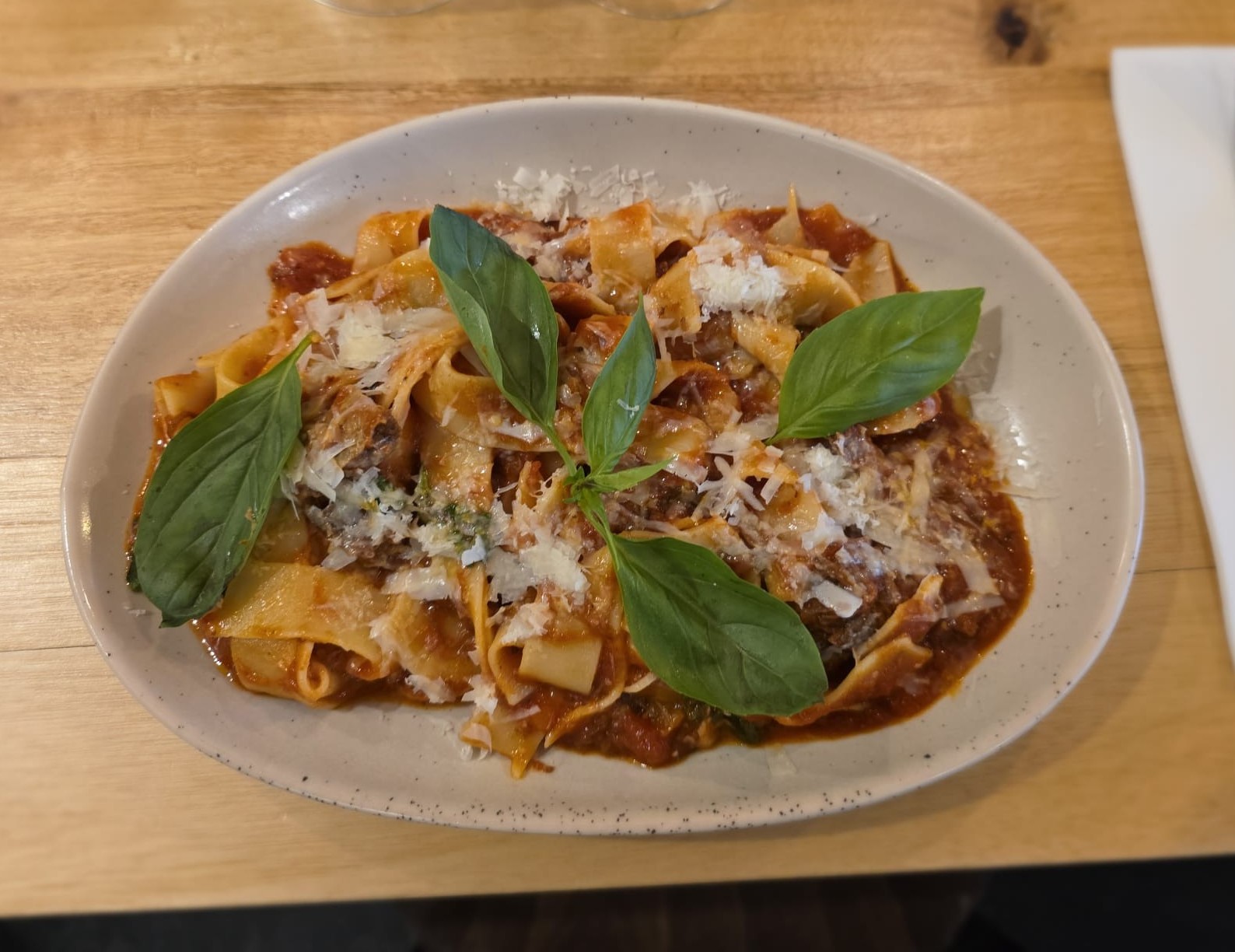 Pappardelle with beef rag&ugrave; topped with parmesan and basil